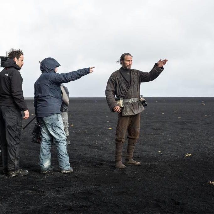 Mads Mikkelsen on set with the crew directing a scene